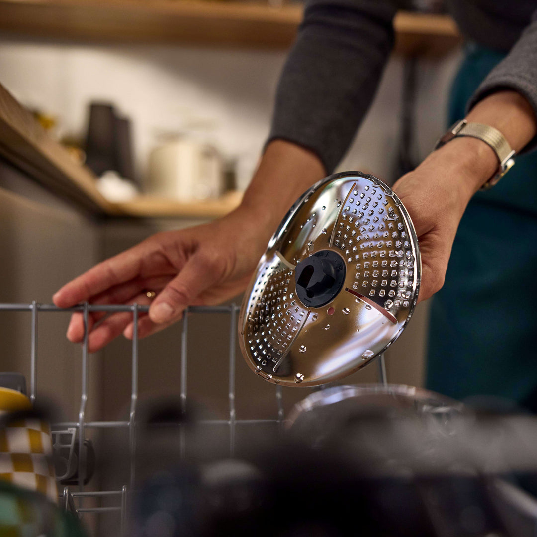 a person washing blade cover and peeler