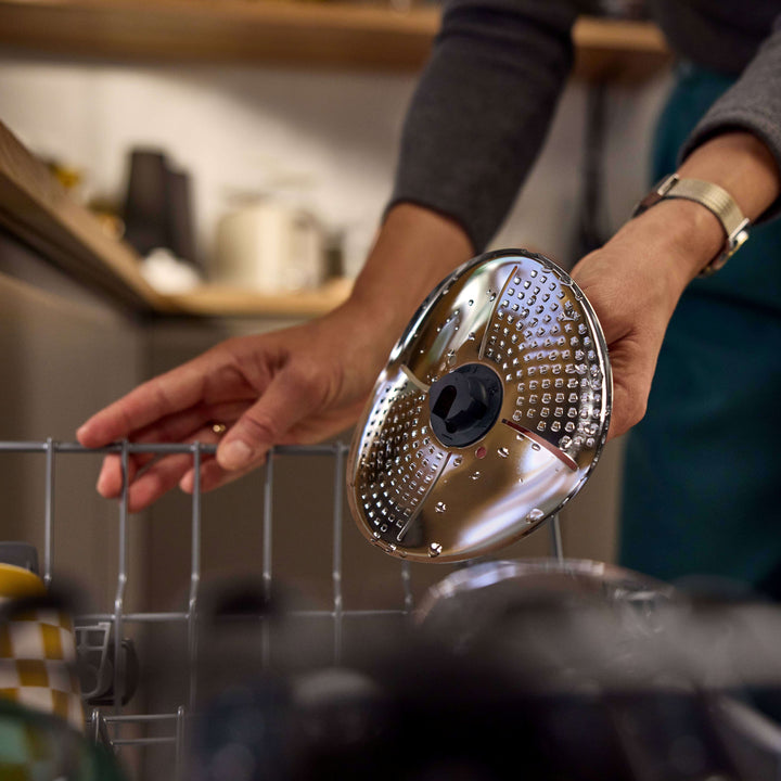 a person washing blade cover and peeler