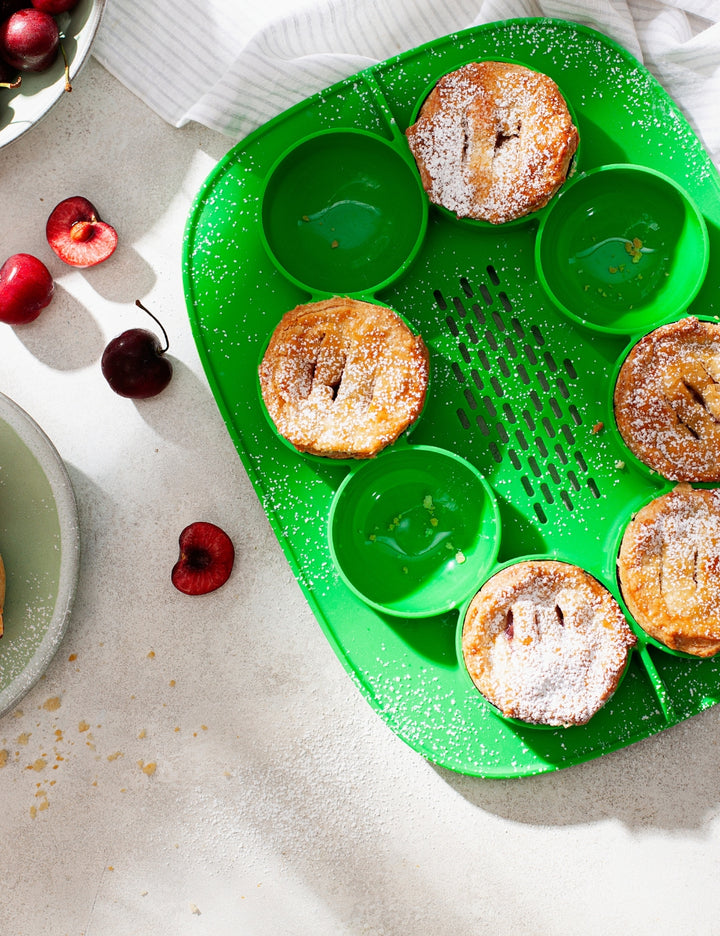 Green Thermomix The Nester silicone insert inside the Varoma tray for cooking and food preparation.