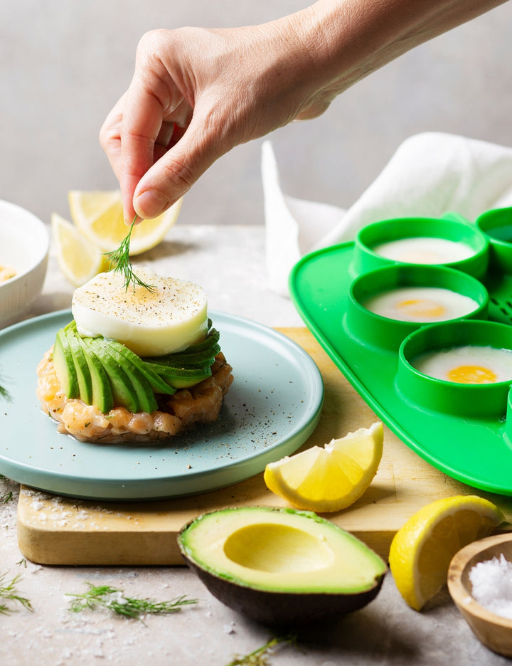 Green Thermomix The Nester silicone insert inside the Varoma tray for cooking and food preparation.