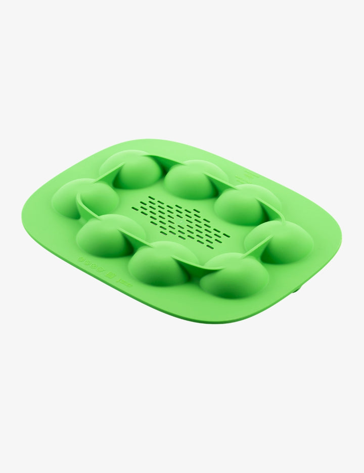 Green Thermomix The Nester silicone insert inside the Varoma tray for cooking and food preparation.