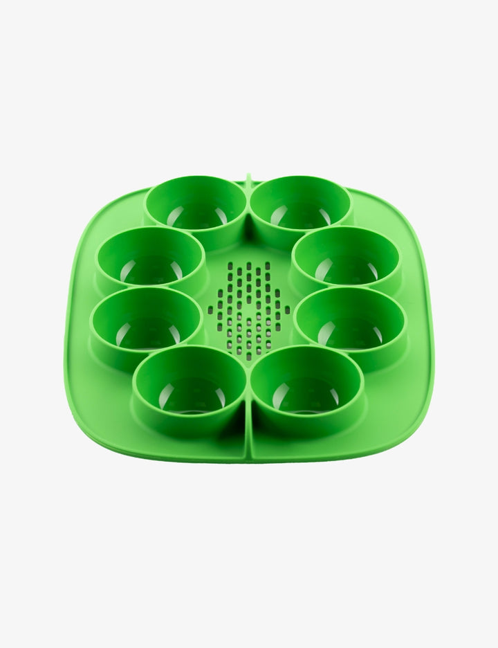 Green Thermomix The Nester silicone insert inside the Varoma tray for cooking and food preparation.